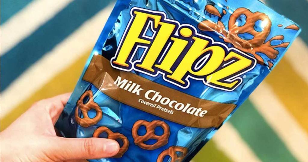 Hand holding Flipz Milk Chocolate Pretzels