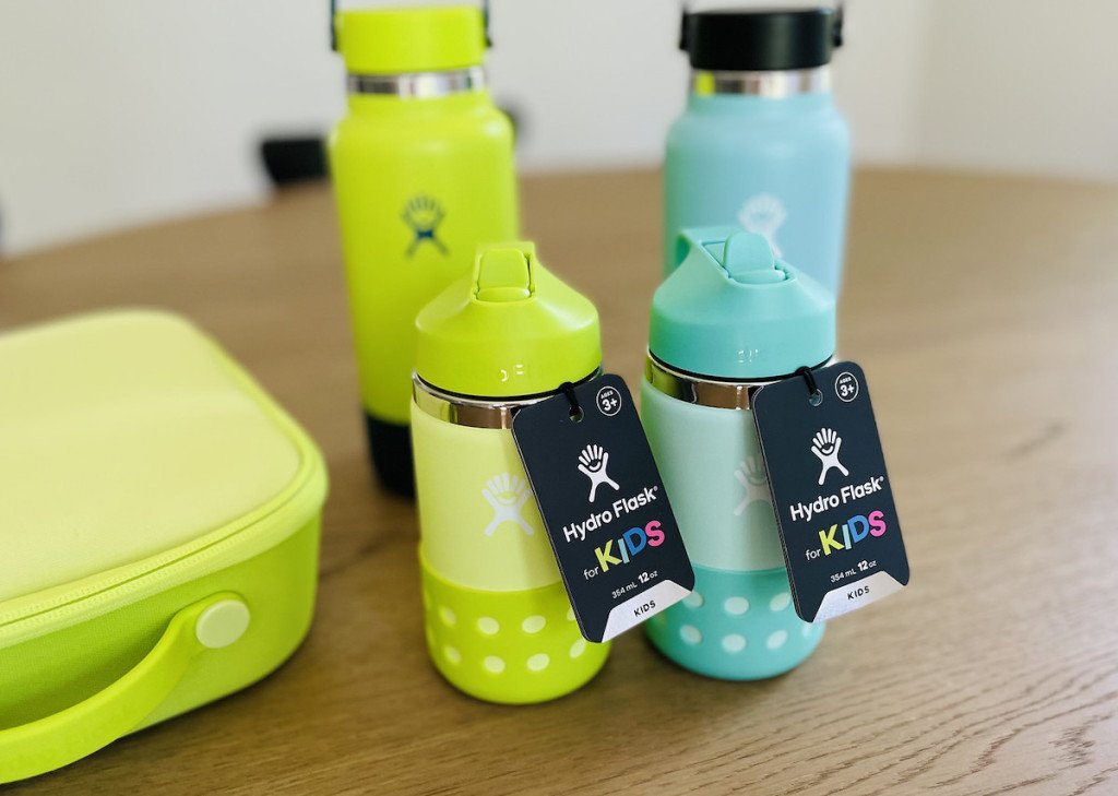two kids hydro flask water bottles with tags sitting on table