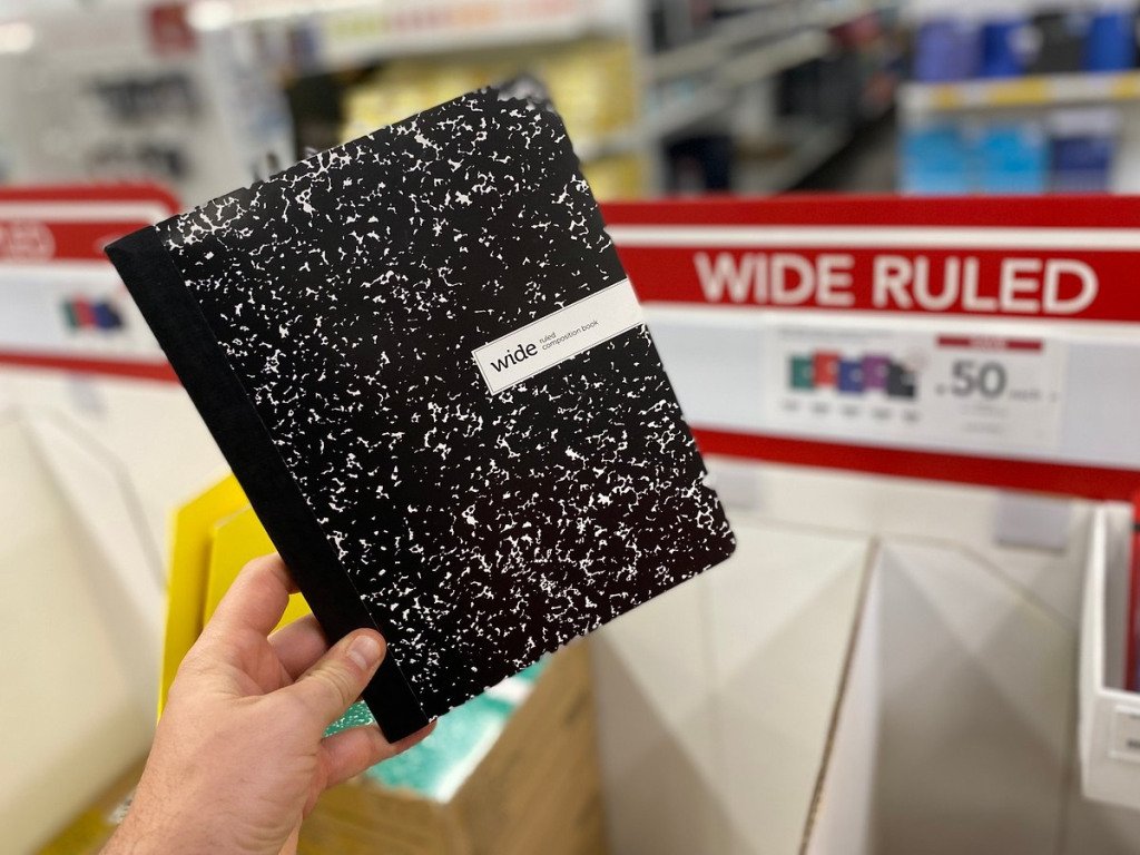 holding composition book at Office Depot